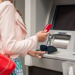 woman using no-fee checking account at atm