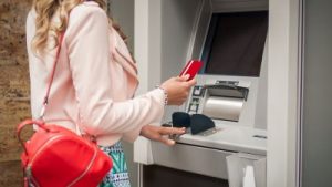 woman using no-fee checking account at atm