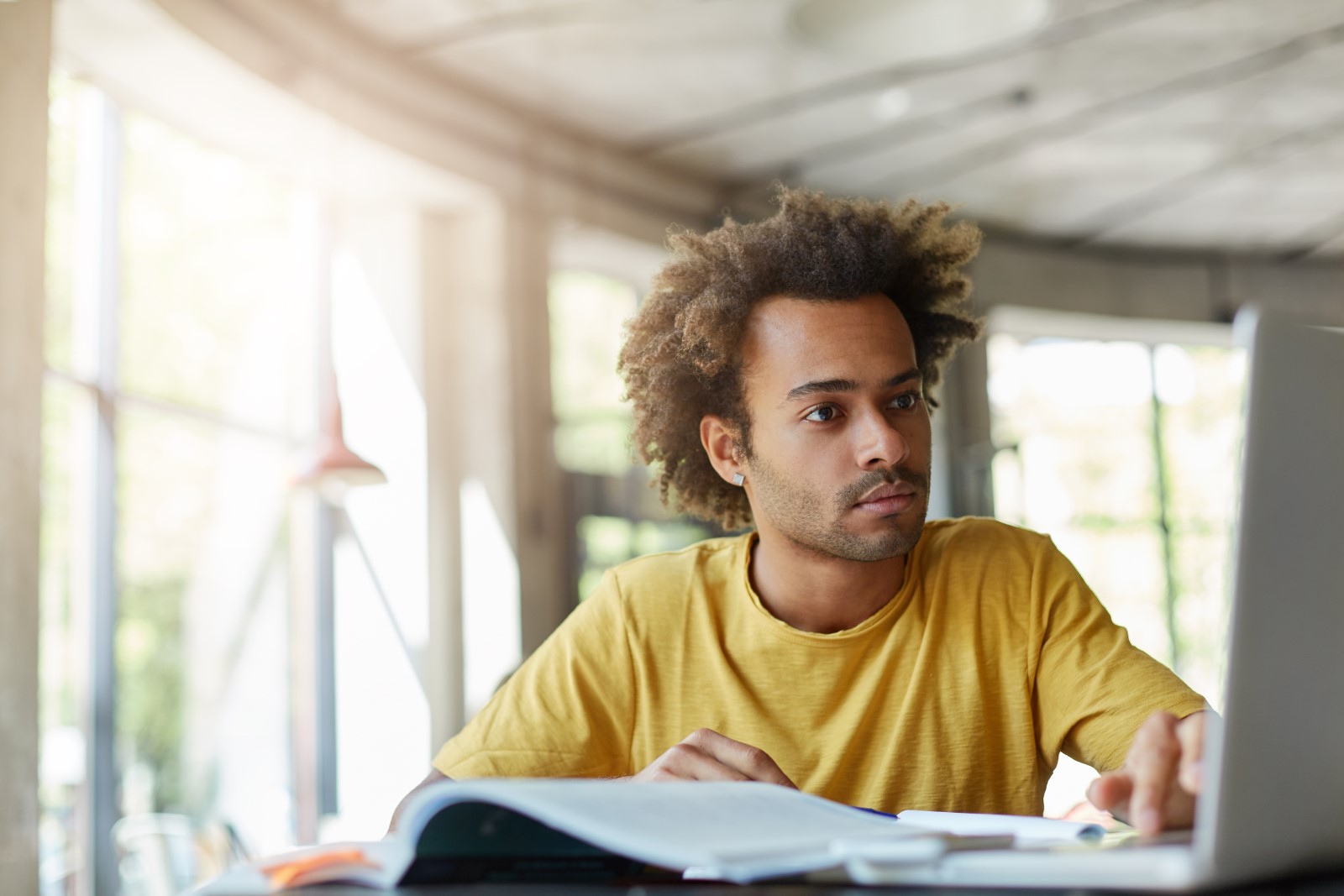 A young man reading about identity theft.