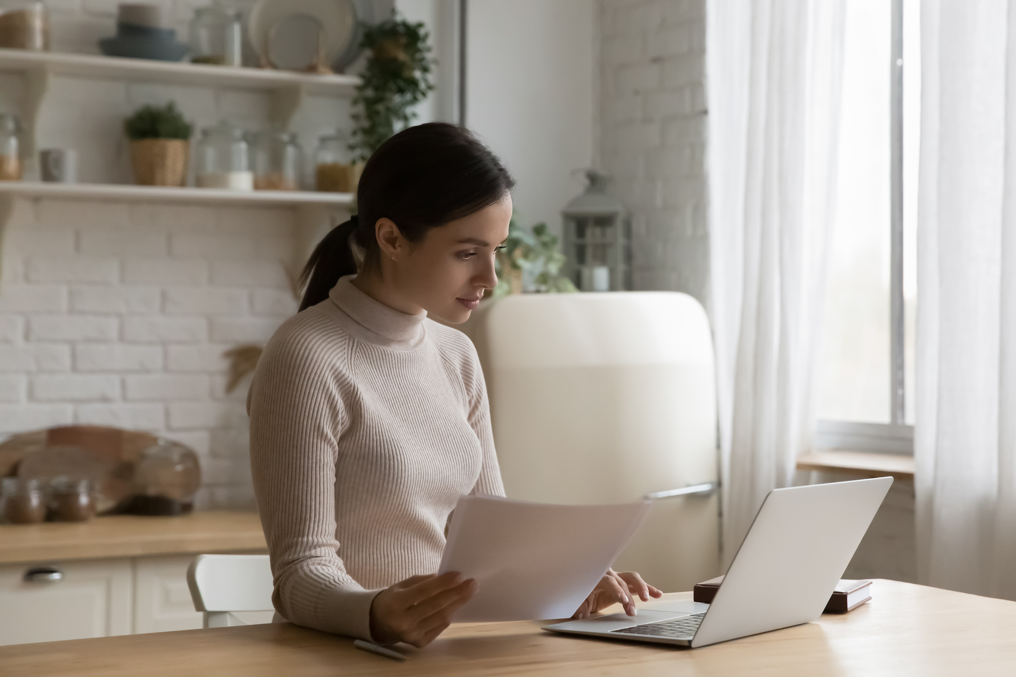 A woman does research on her laptop about how many personal loans you can have at once.